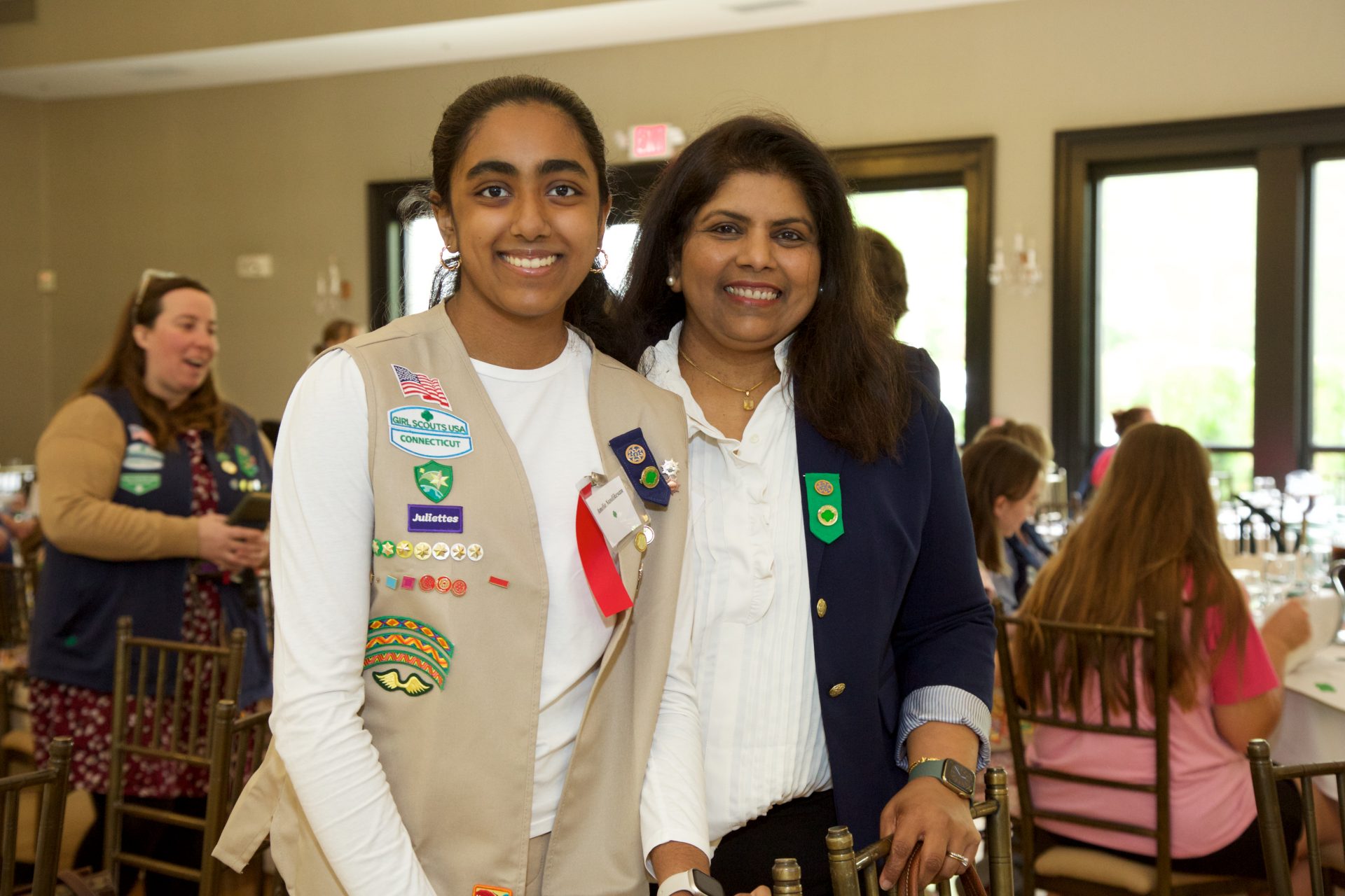 girl scout with mother in girl scout uniform