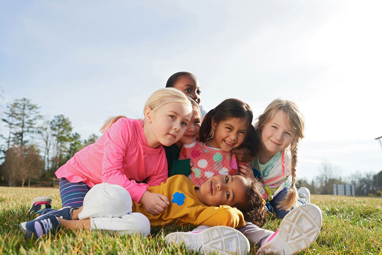 girls sitting in the grass