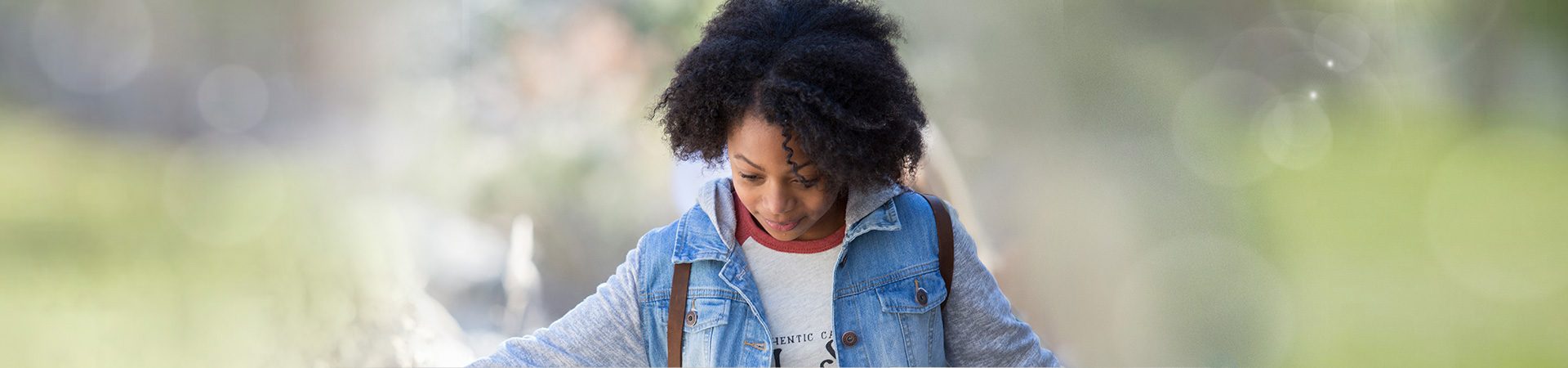  girl walking outside looking down 